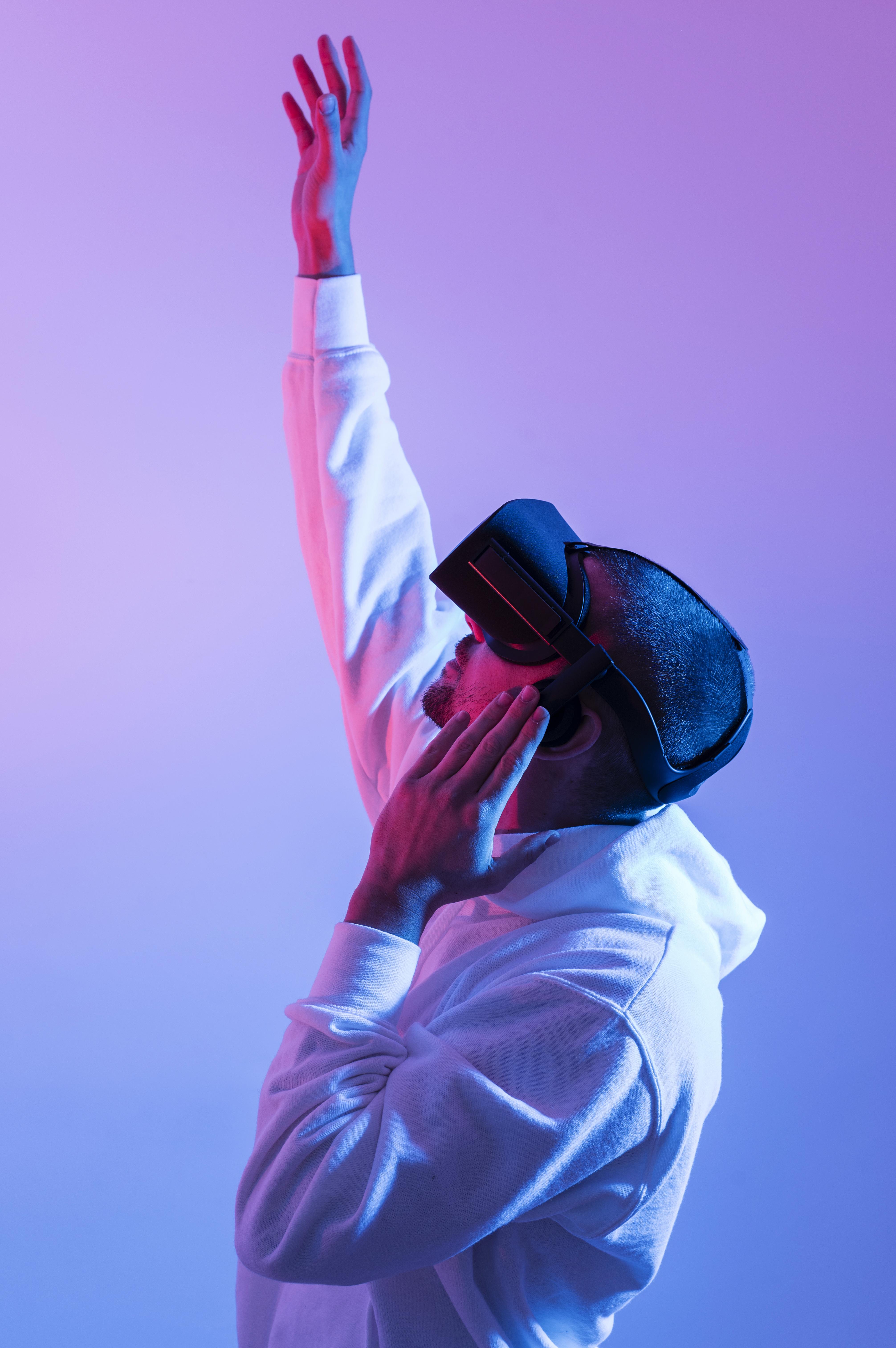 man using a vr with his hands raised